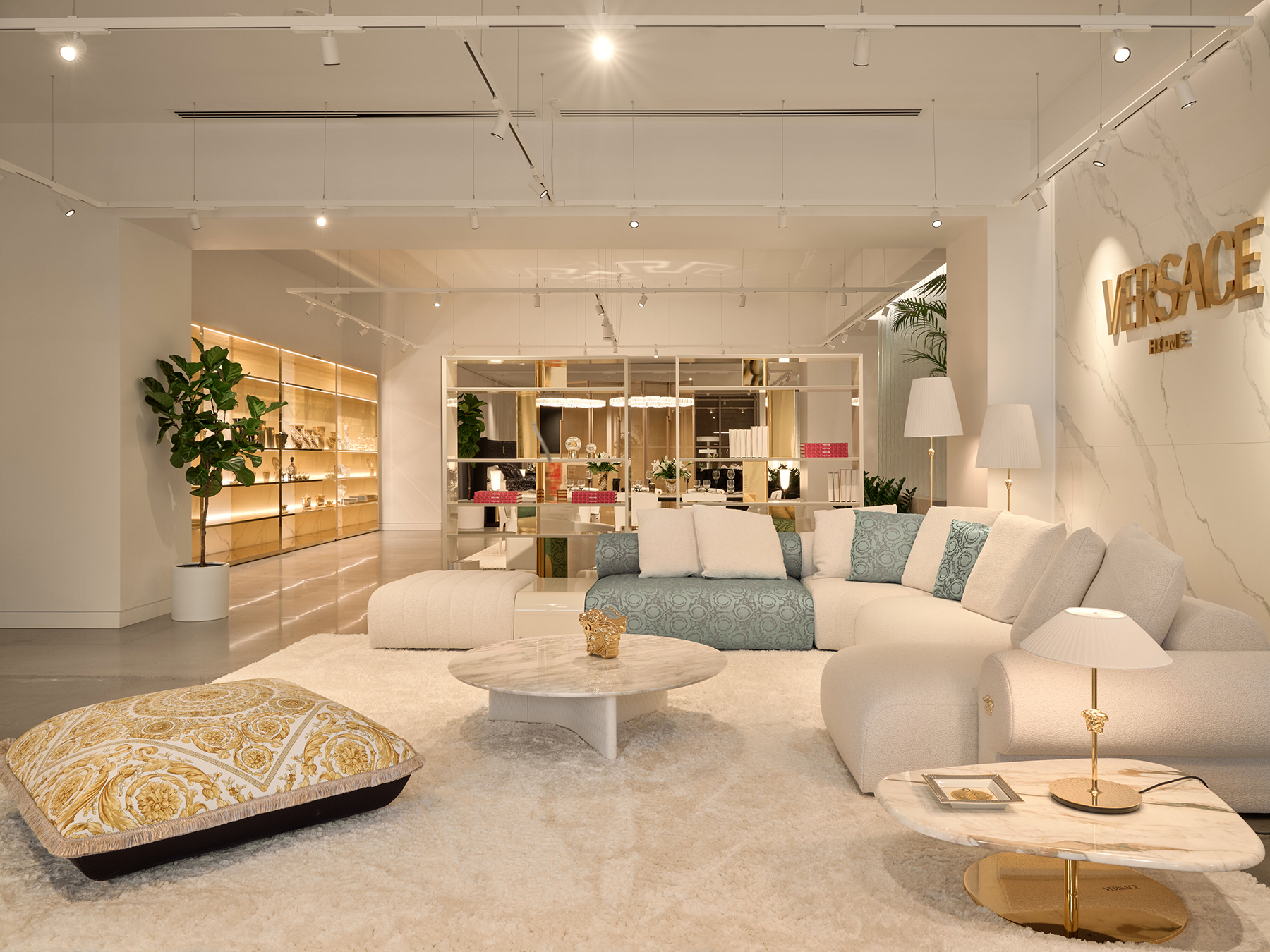 Versace Home at Maison Territo a sculptural living room composition with voluptuous lines and golden finishes embodying Italian Glamour