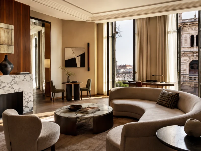 Milanese interiors often balance material richness with disciplined proportion and a strong sense of intimacy. Elegant Milanese interior with curved seating, marble accents, and warm natural light