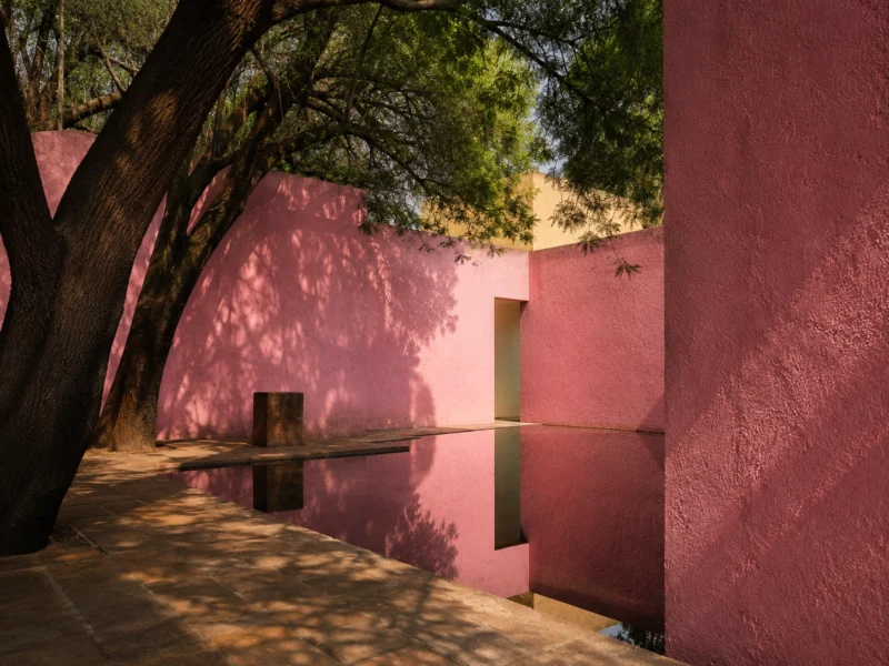 Pink modernist courtyard with a reflecting pool and mature trees in Mexico City. AI ChatGPT